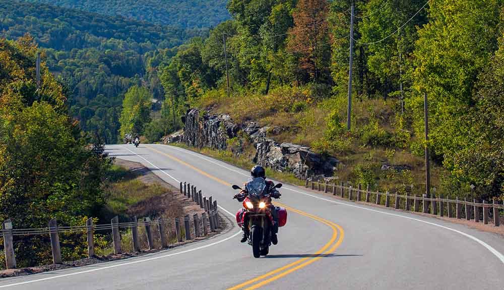 A person riding a motorcycle down a winding road.