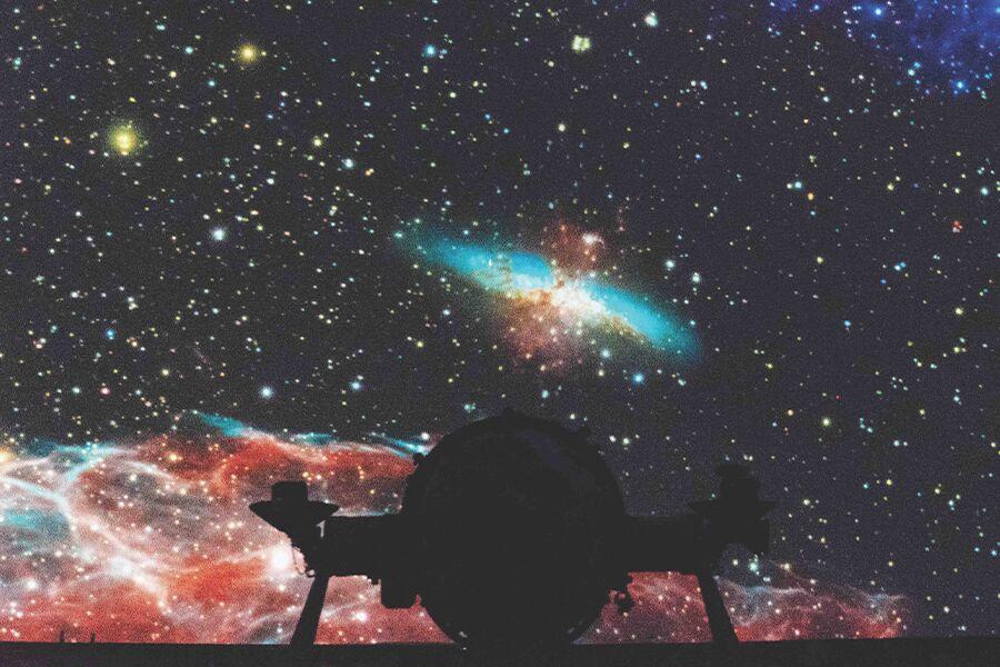An image of a starry sky with a man standing in front of it.