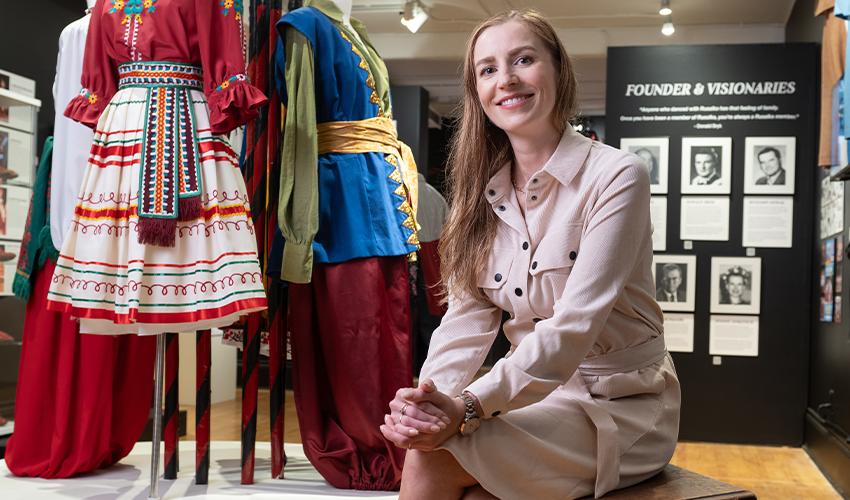 A woman sitting on a floor in a store.
