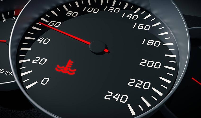 A car dashboard with a speedometer and other gauges.