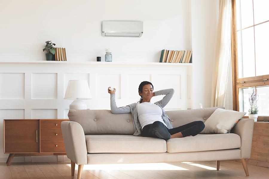 A woman sitting on a couch in a living room.