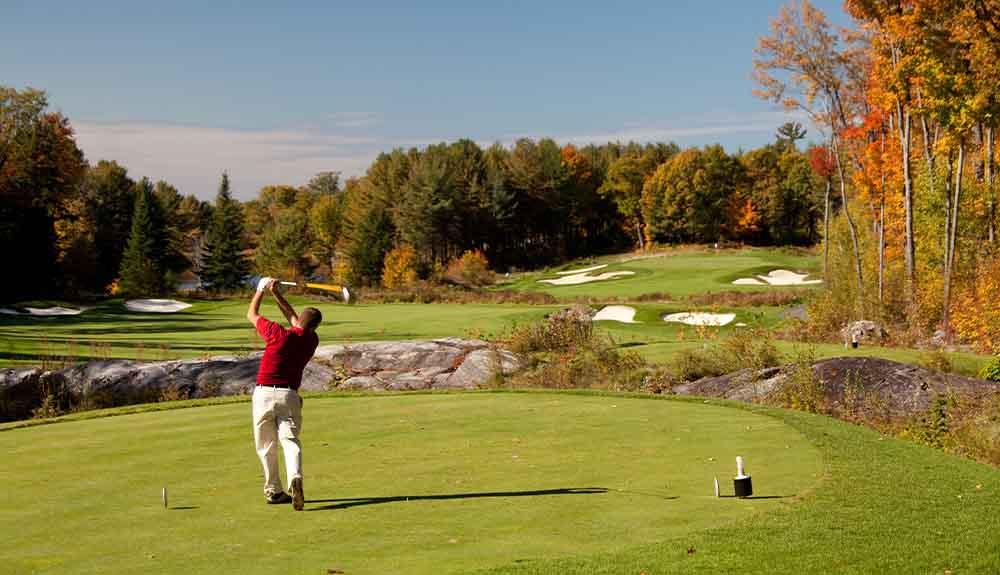 A man swinging a golf club.