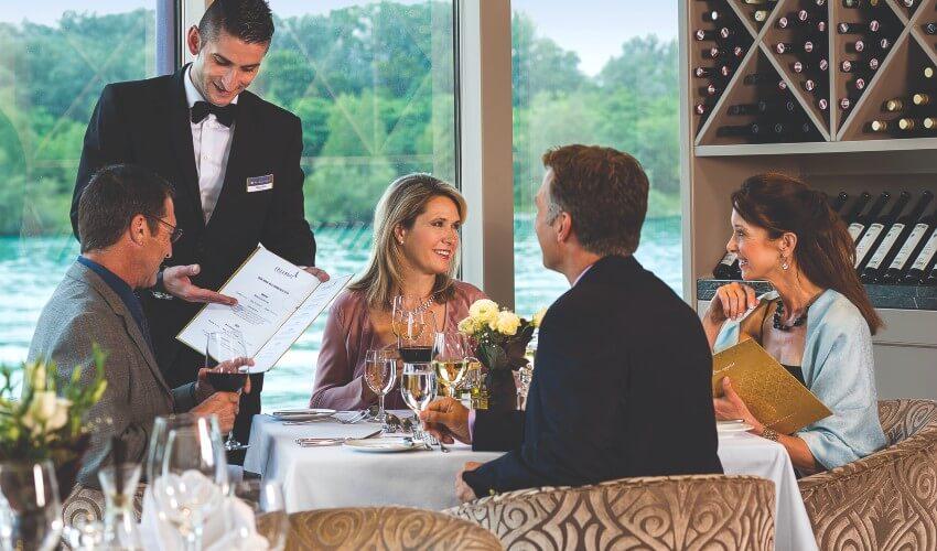 A group of people sitting at a table in a restaurant.