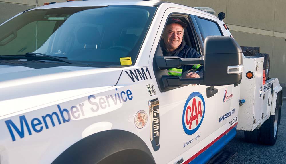 A man sitting in the driver's seat of a truck.