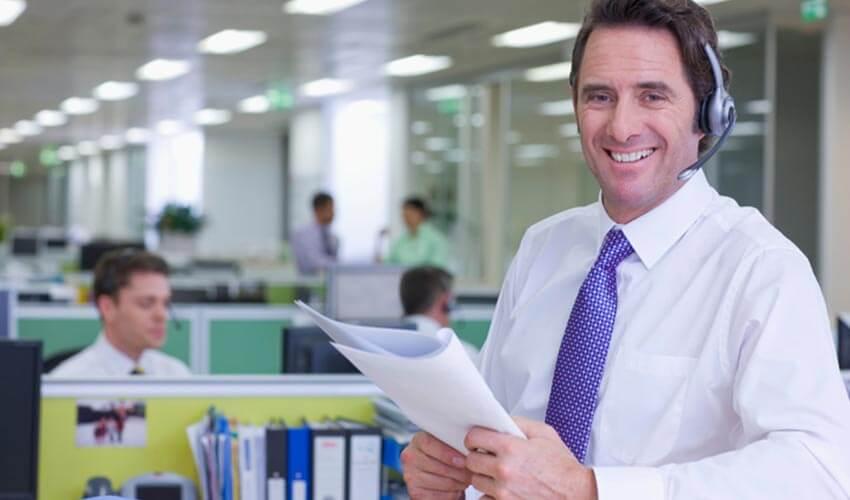 A man wearing a headset in an office.