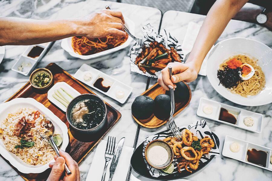 A group of people eating food at a table.