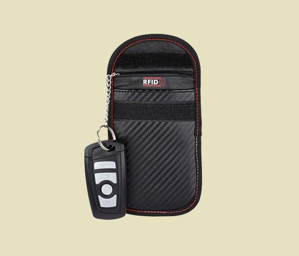 A black pouch with a key ring attached to it.
