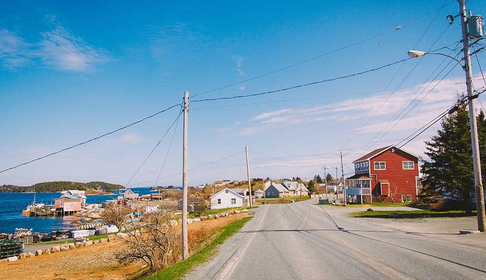 A road with houses and power lines.