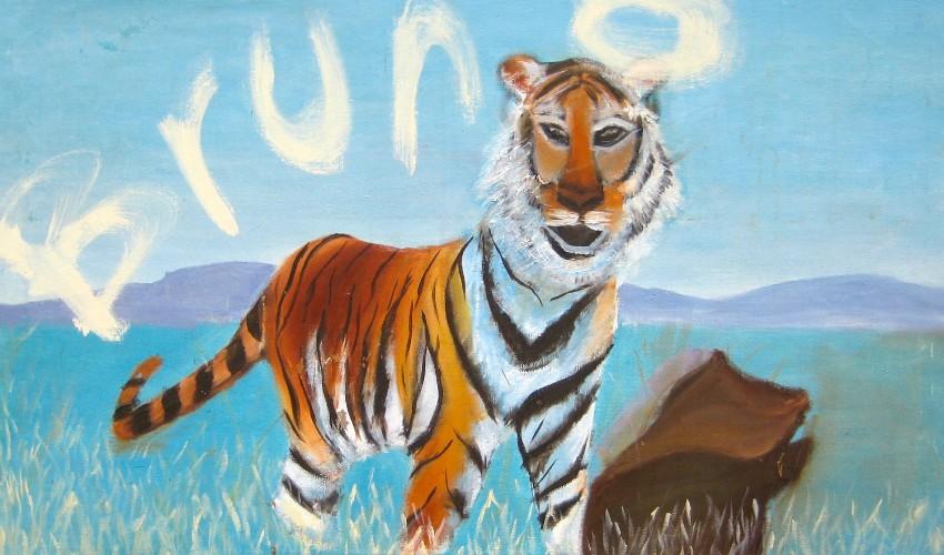 A painting of a tiger standing in grass with the word "bruno" written in the background.