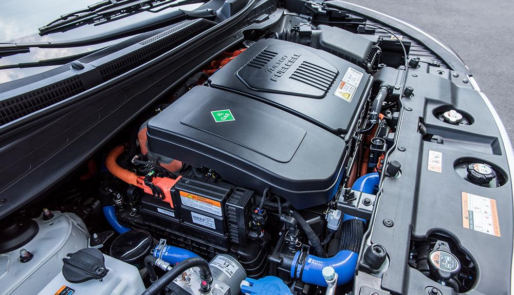 Engine bay of a modern hybrid vehicle with visible orange high-voltage cables.