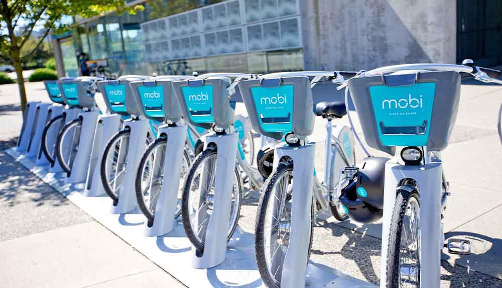 A row of bicycles parked in front of a building.