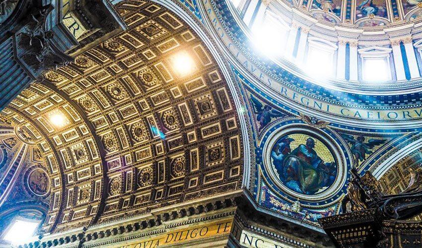 A ceiling of a building with a mural on the ceiling.