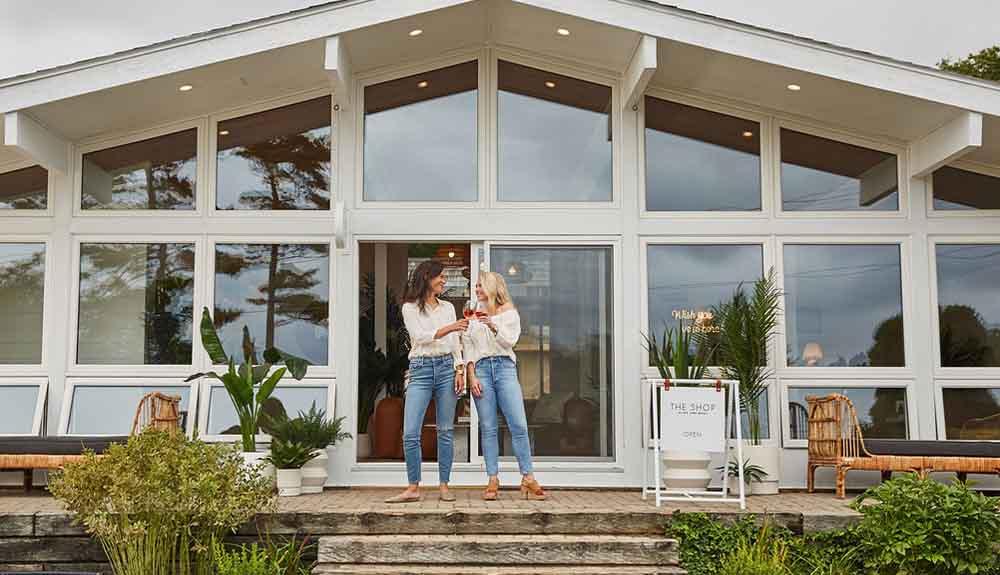 Two women standing in front of a house.