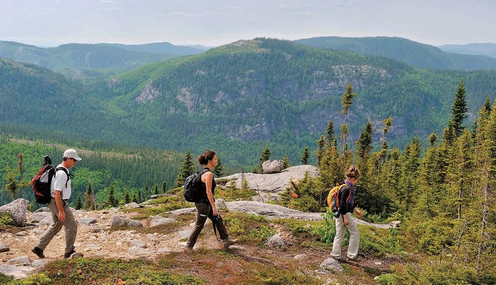 A couple of people hiking on a mountain.