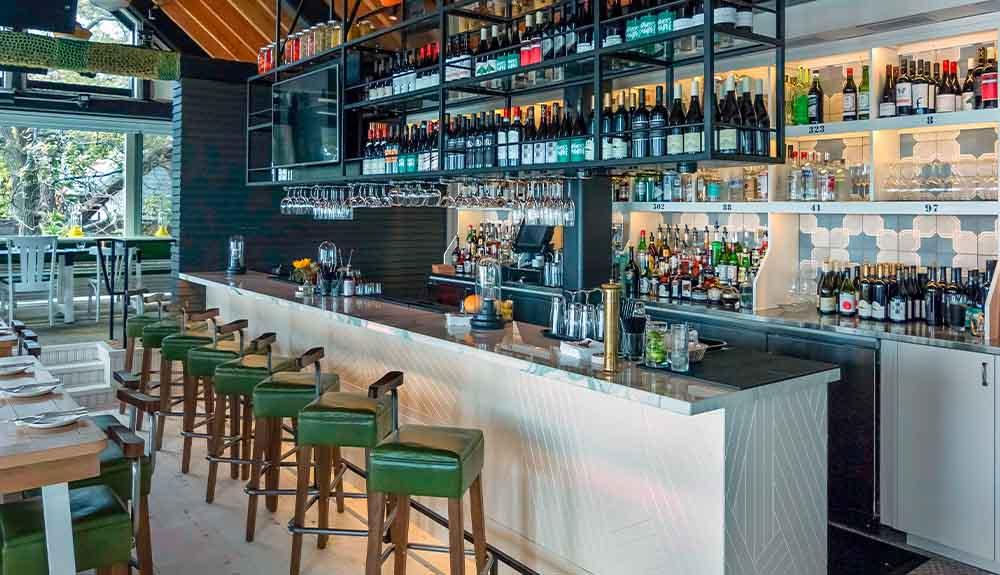 A bar with many bottles of wine.