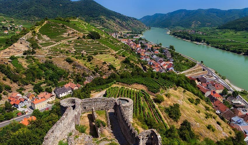 A view of the rhine river and a castle.