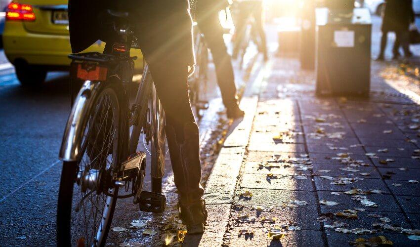 A group of people riding bicycles on a city street.