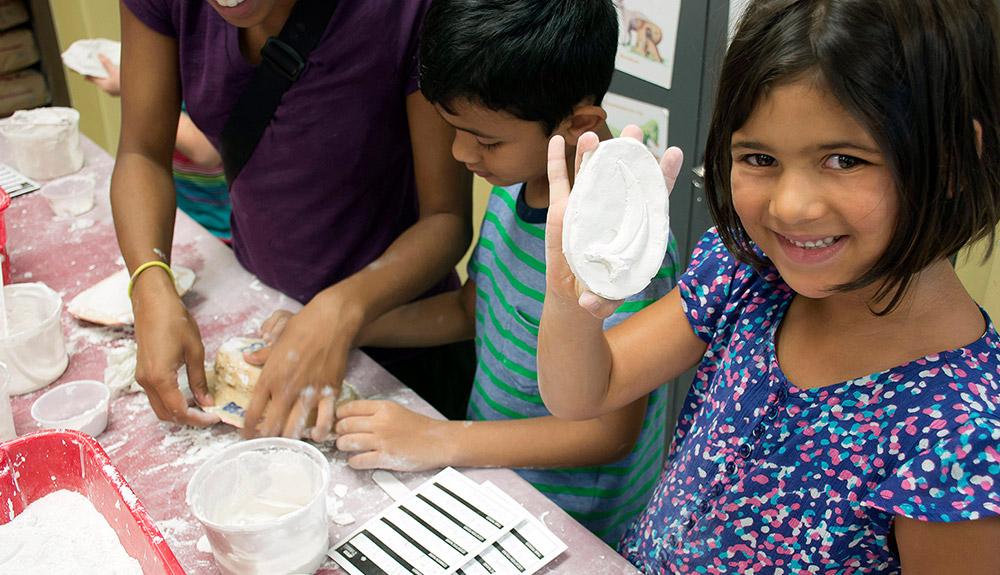 A group of children are making clay.