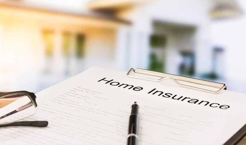 A clipboard with the word home insurance on it.