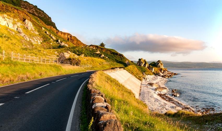 A winding road along the coast of ireland.