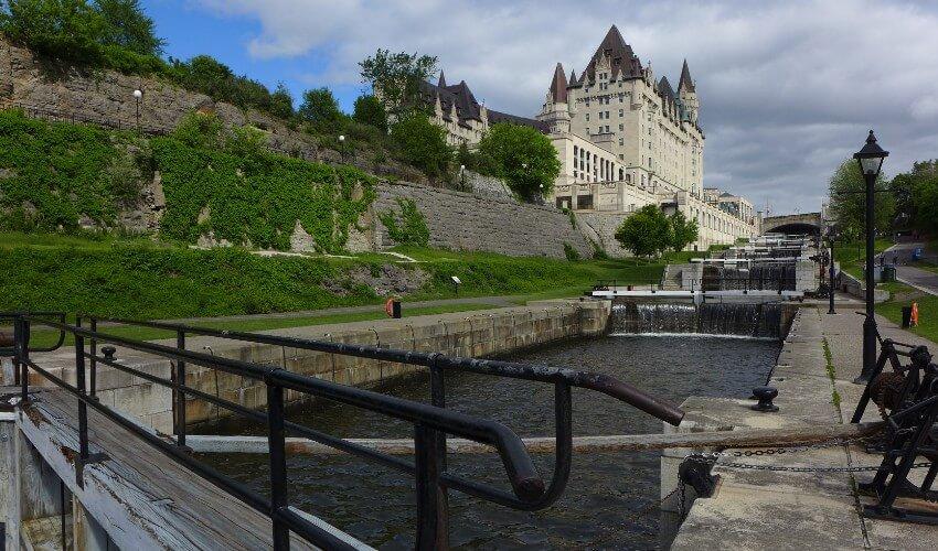 A canal with a castle in the background.