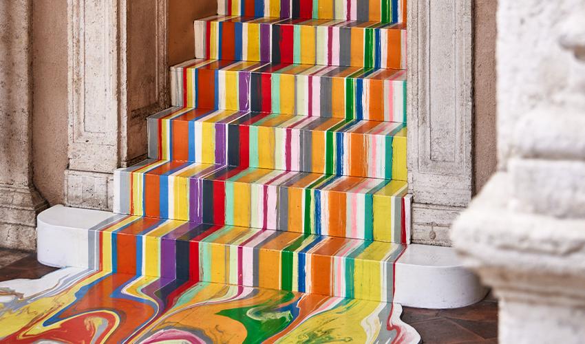 A staircase with colorful stripes painted on it.