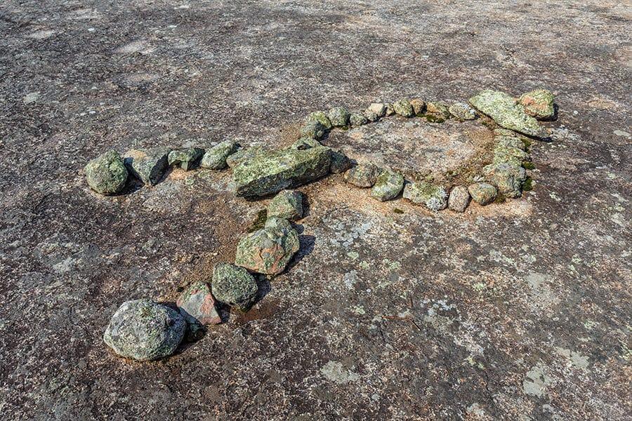 A rock formation with rocks on top of it.