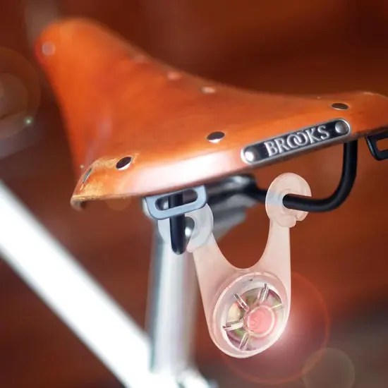 A bicycle seat with a light attached to it.