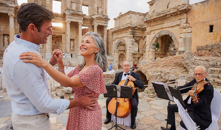 A man and woman dancing in front of a group of musicians.