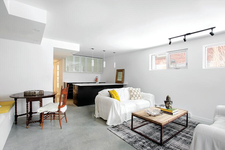 A living room with white furniture and white walls.