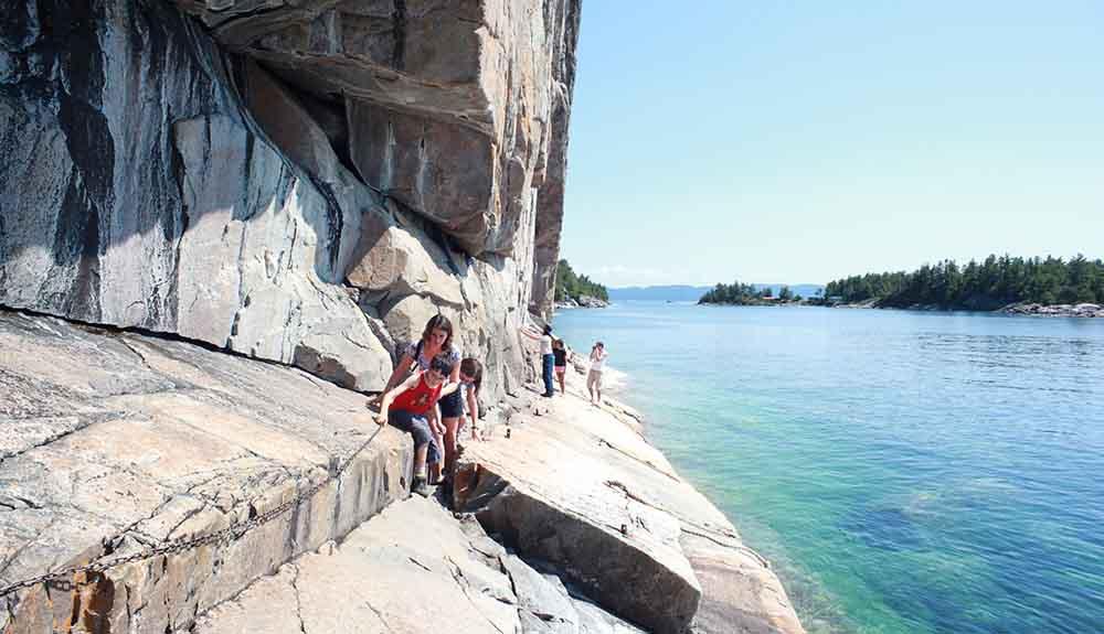 A group of people standing on the edge of a cliff.