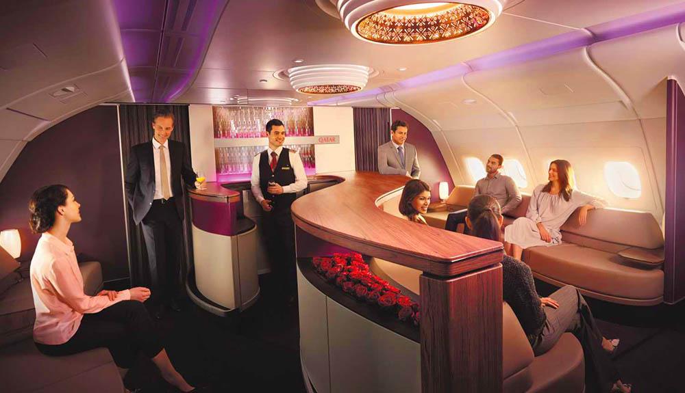 A group of people sitting around a bar in an airplane.