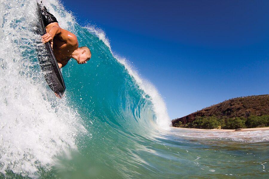 A surfer riding a wave on a surfboard.