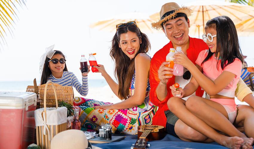 Group of friends enjoying a picnic on the beach.