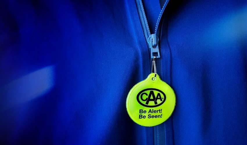 A blue jacket with a yellow tag on it.