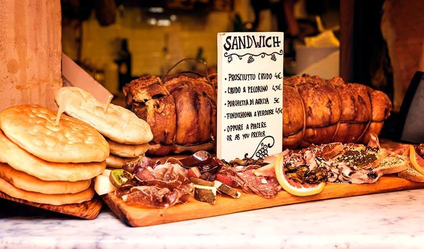 A display of bread and meat on a table.