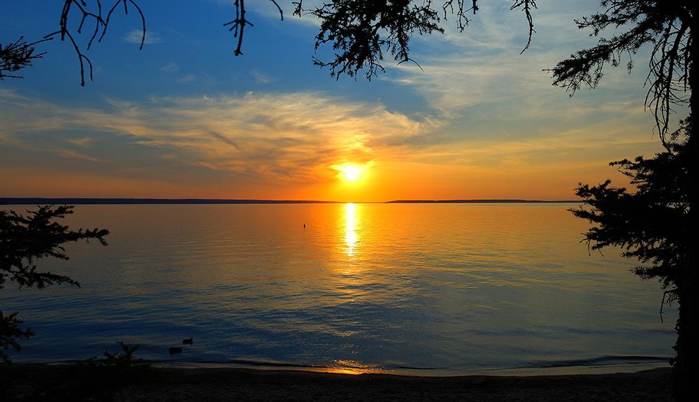 The sun is setting over a body of water.
