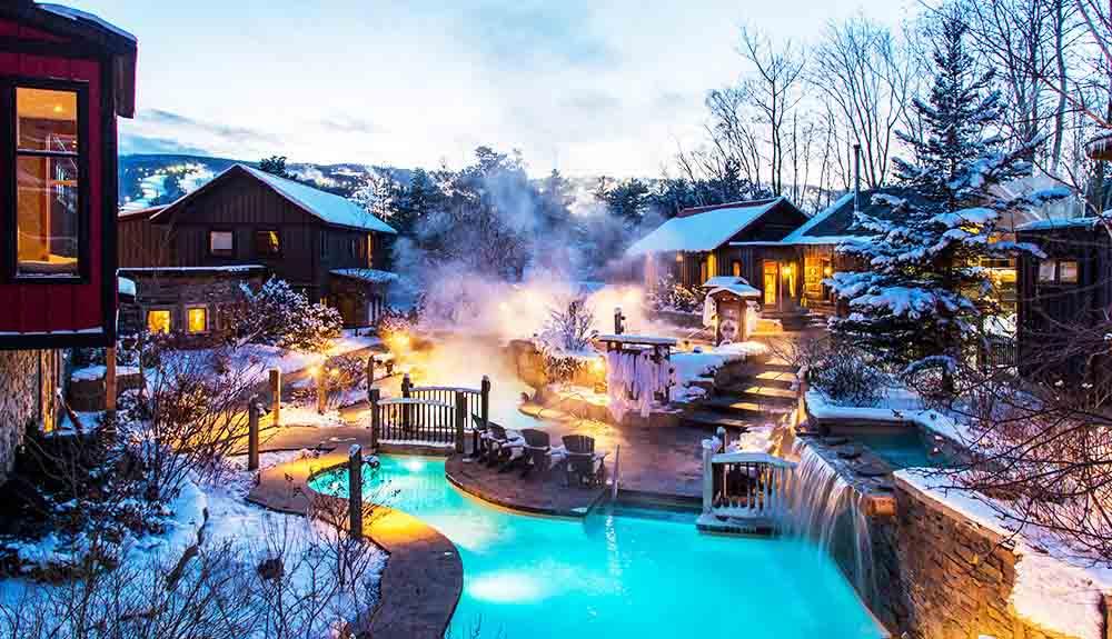 A hot tub in the middle of a snow covered area.