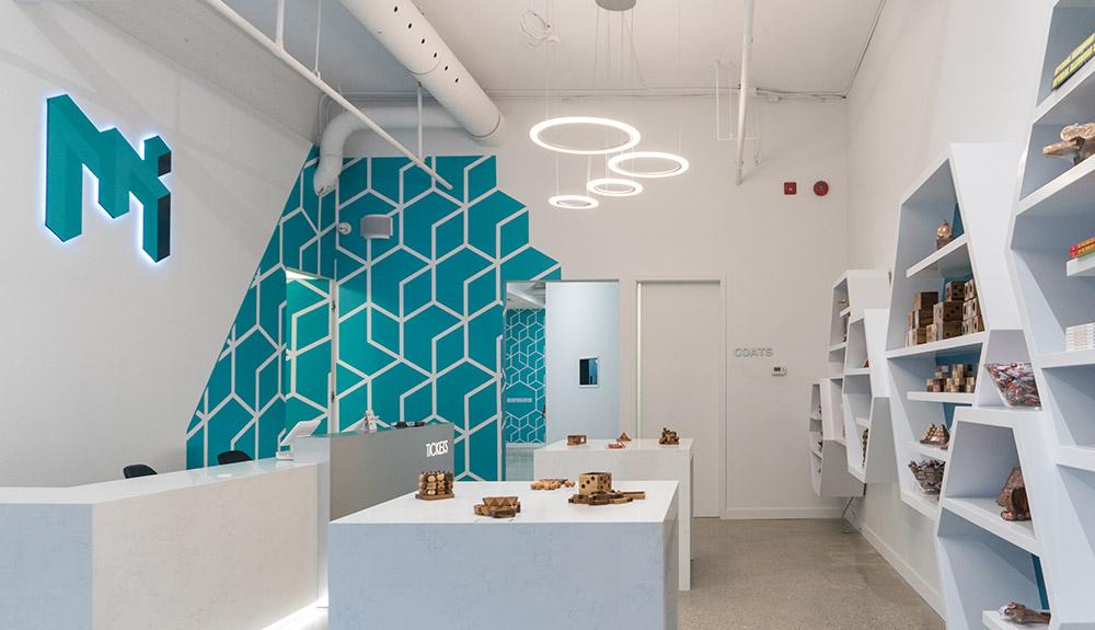 The interior of a shoe store with a blue wall.