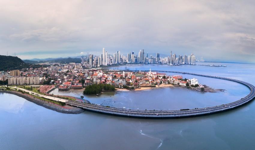An aerial view of a city with a bridge over the water.