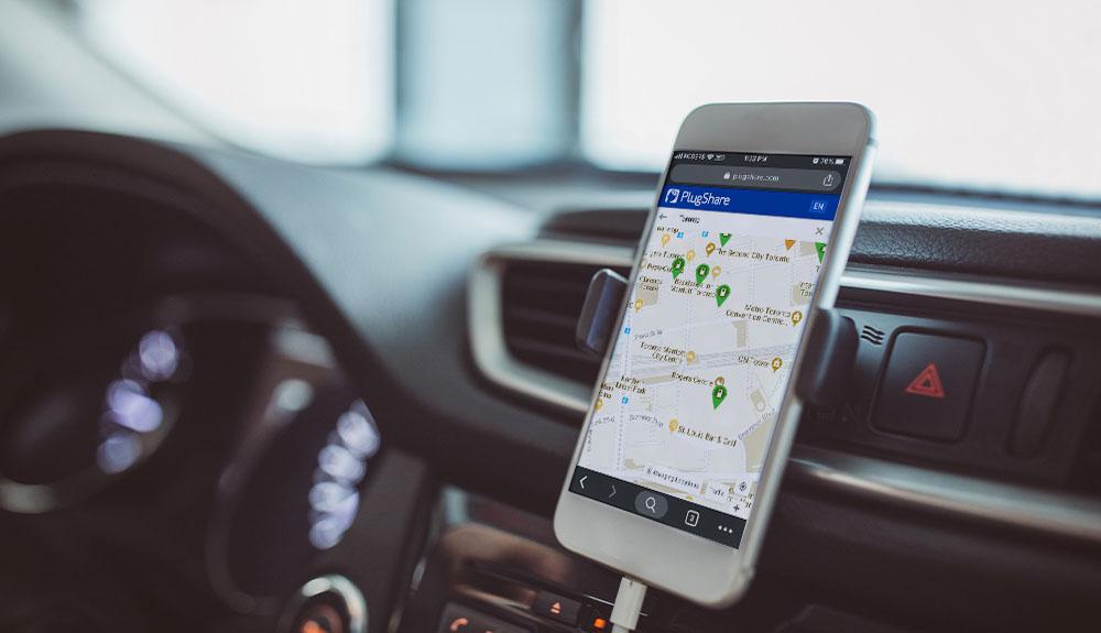 A cell phone with a map on it in a car.