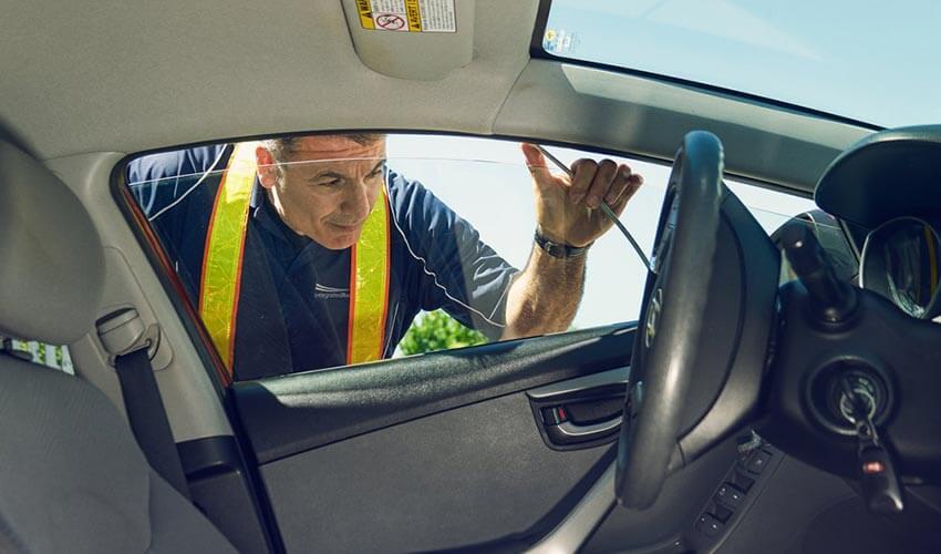 A man looking out of the driver's side window of a car.