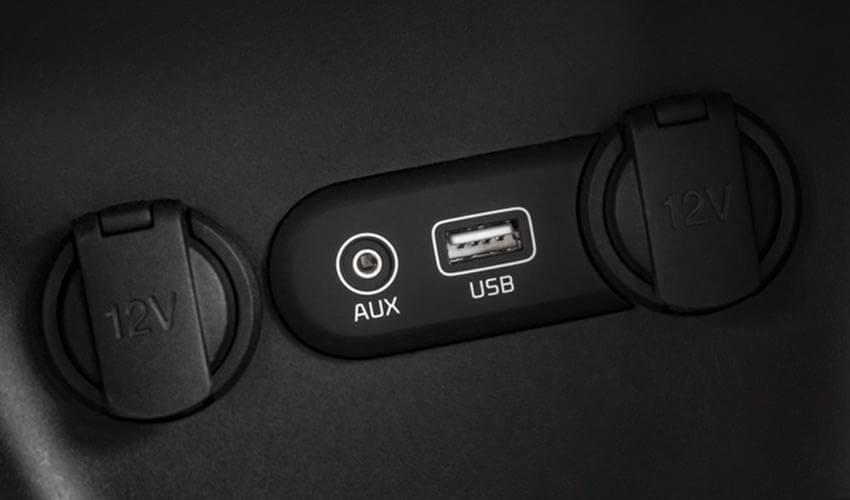 A black car with two usb ports on the dashboard.