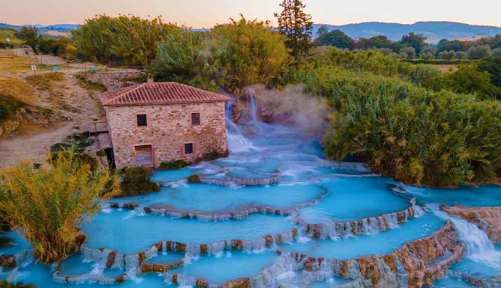 An aerial view of a blue water spring in greece.