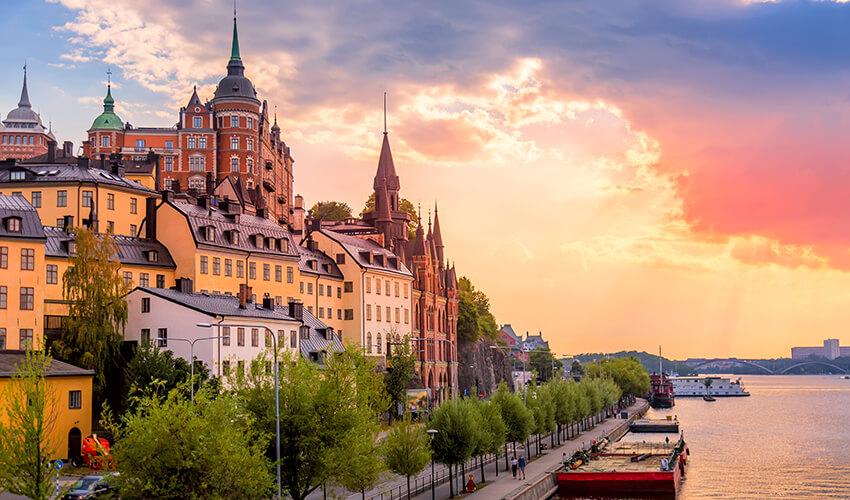 Waterfront buildings at sunset in a european city.