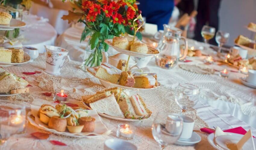 A table set up with sandwiches and tea.