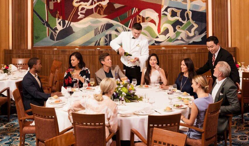 A group of people sitting at a table in a restaurant.
