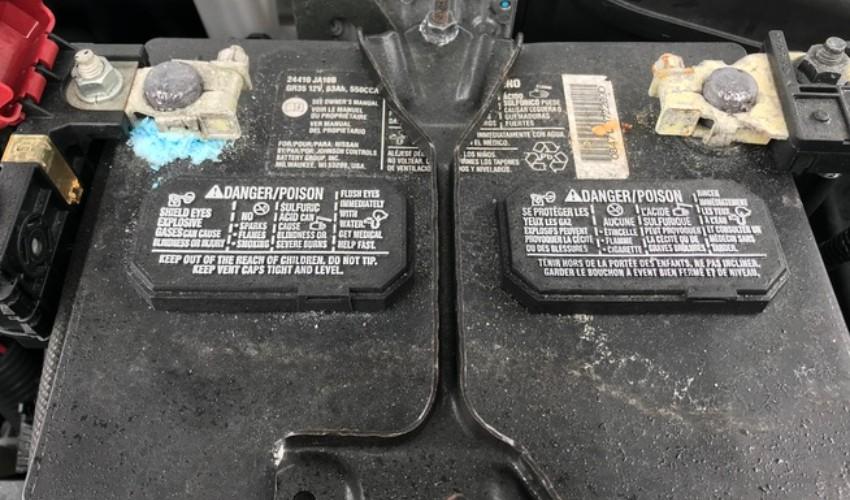 A picture of a car battery with a label on it.