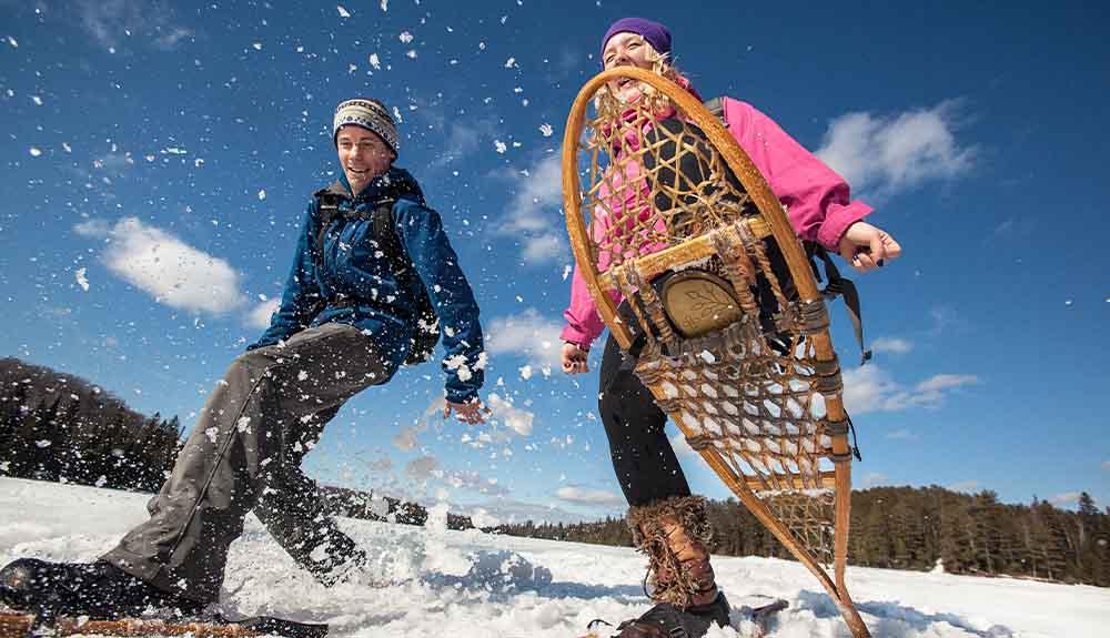 Two people on snowshoes in the snow.